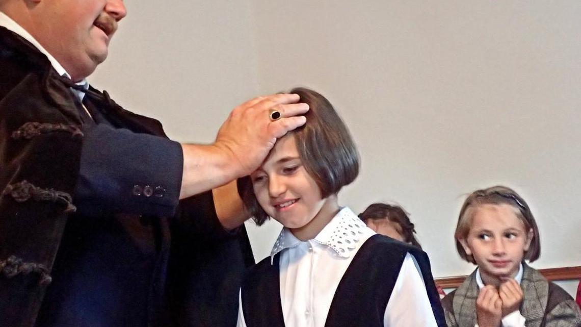 Pastor Karoli Molnar proclaims the baptism of a girl from the Emmaus Home for abandoned children in Targu Mures, Romania, on October 2, 2015. The baptism was held at a small church in a village outside of Targu Mures. Molnar’s wife, Eszter, oversees orphanages in the region on behalf of the Bellingham-based Christian outreach organization Kidstown International. A group of Americans travelled in September 2015 to Romania to visit homes that benefit orphans and abandoned children. The nonprofit Kidstown International of Bellingham, Washington, and Tacoma Rotary 8 help fund the homes.