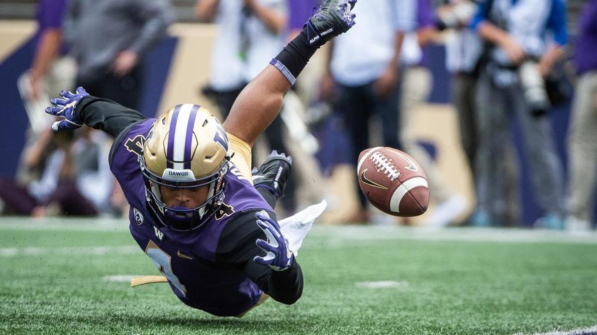 Washington defensive back Austin Joyner (4) dives in an attempt to corral a punt in the second quarter. The University of Washington played North Dakota in a NCAA football game at Husky Stadium in Seattle, Wash., on Saturday, Sept. 8, 2018.