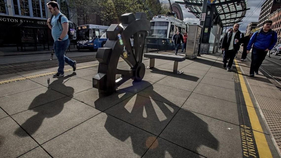 Commuters hop off the Link light rail train Tuesday at the University of Washington Tacoma campus while a bus drops off passengers at the Washington State History Museum in Tacoma. Sound Transit proposes spending $50 billion over the next 25 years to expand light rail, commuter train and express-bus services across the Puget Sound region. Some of that money would be spent to expand light rail from Federal Way to the Tacoma Dome Station and eventually on to the Tacoma Mall and Tacoma Community College. Voters would need to approve nearly $27 billion in new taxes this fall for the projects to move ahead.