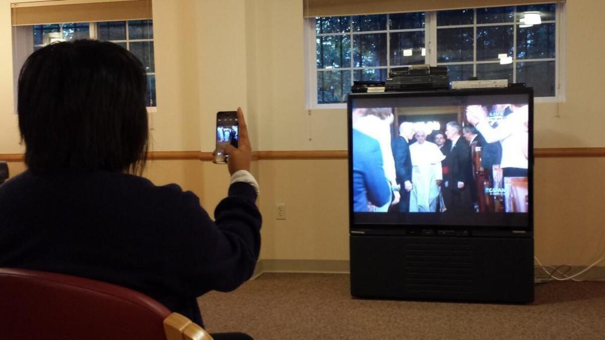 
Diana Jorda takes a photo Thursday morning of Pope Francis walking into the U.S. House of Representatives in Washington, D.C. Jorda organized a viewing party at Sisters of St. Francis in Tacoma.
