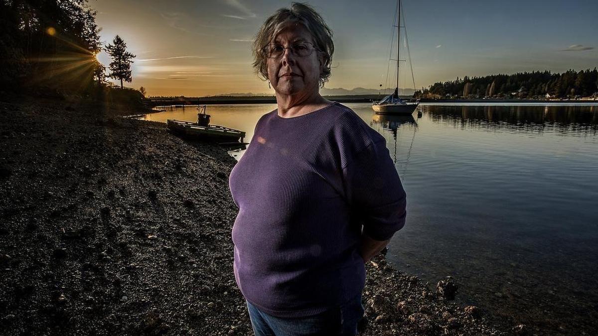 Dale Skrivanich, standing on the tidelands in Vaughn, Washington, said someone has to fight to protect the bay her family has called home for years. Dale Skrivanich, along with other residents of Vaughn Bay, contend that runoff pollution is adversely impacting the shellfish in the bay.