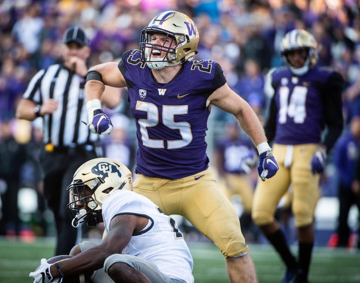 The Seahawks used their first choice of the fifth round in the NFL draft Saturday to select University of Washington linebacker Ben Burr-Kirven (25). Here he celebrates doing what he did a lot at UW: delivering a hit, this one Colorado’s Tony Brown (18) in an October game at Husky Stadium.