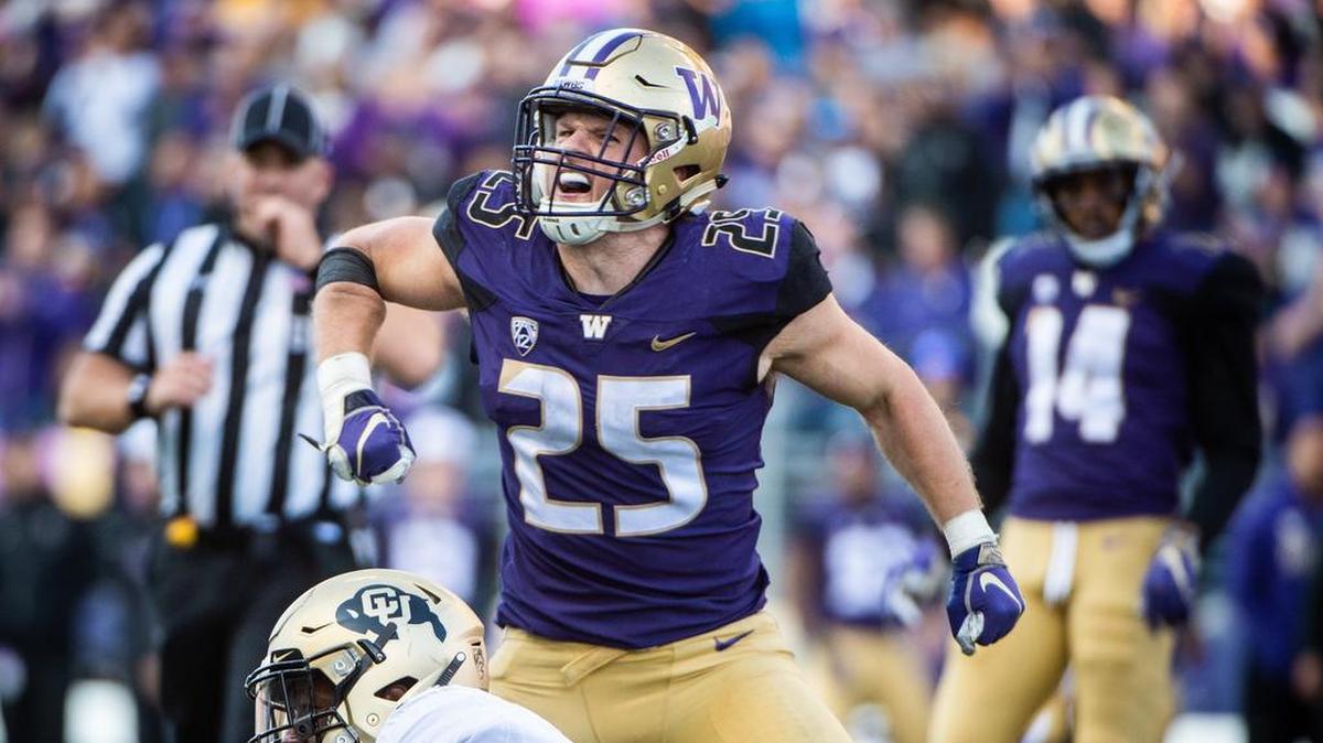 The Seahawks used their first choice of the fifth round in the NFL draft Saturday to select University of Washington linebacker Ben Burr-Kirven (25). Here he celebrates doing what he did a lot at UW: delivering a hit, this one Colorado’s Tony Brown (18) in an October game at Husky Stadium.