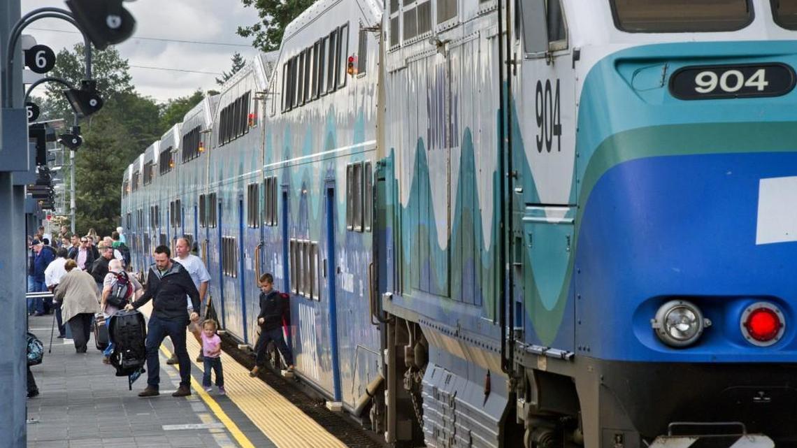 Riders exit the Sounder, a commuter train that runs between Tacoma and Seattle, at the Tacoma Dome Station.