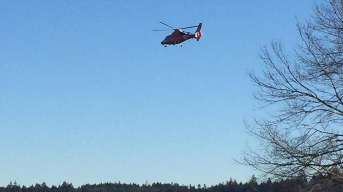 A U.S. Coast Guard helicopter searches for a man who went missing in his kayak early Wednesday morning in north Mason County. The kayak was recovered.