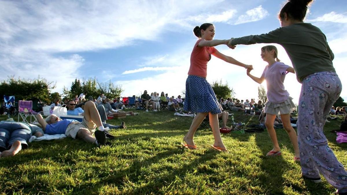 
Children dance during a summer concert at the Curran Apple Orchard Park in University Place in 2005. The city’s parks and recreation programs are facing cuts in the next few years.
