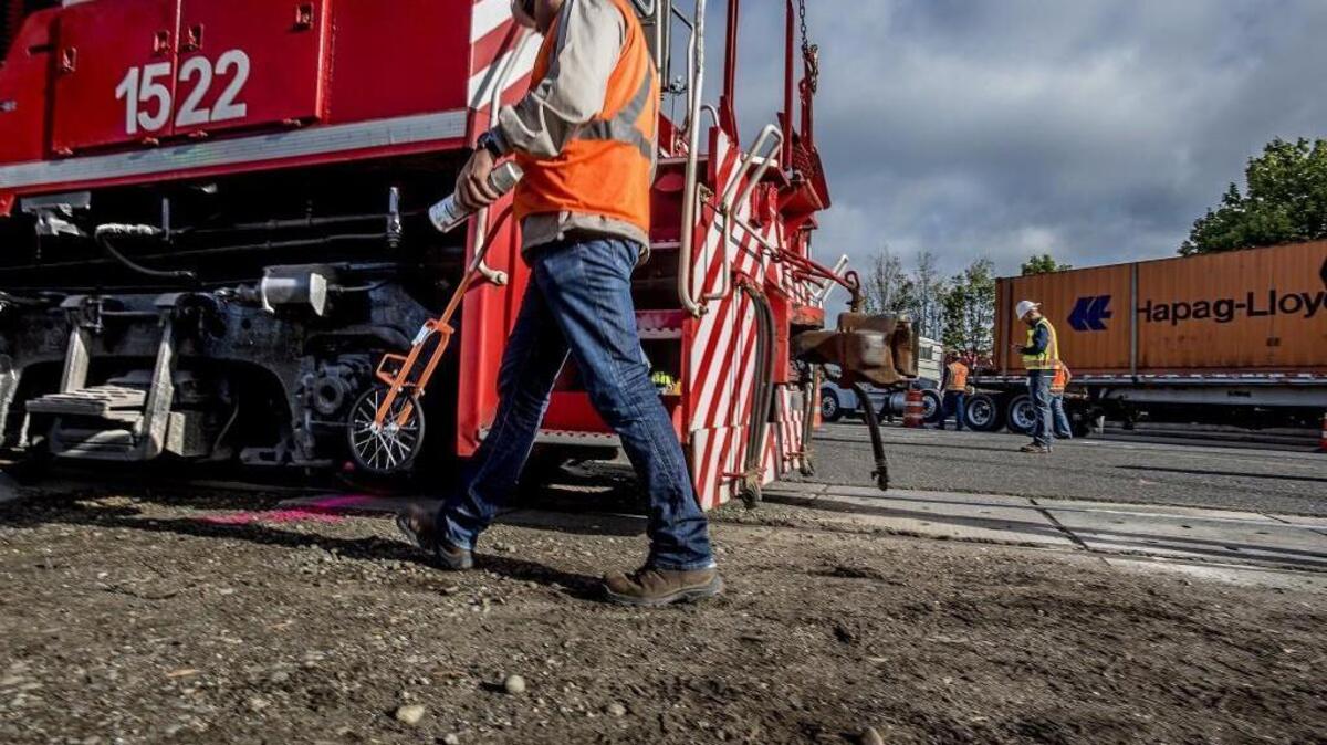 
Employees of Tacoma Rail at the scene of a train crash that cause a derailment near the rail crossing at the Port of Tacoma Road Thursday morning Sept. 3, 2015. 

