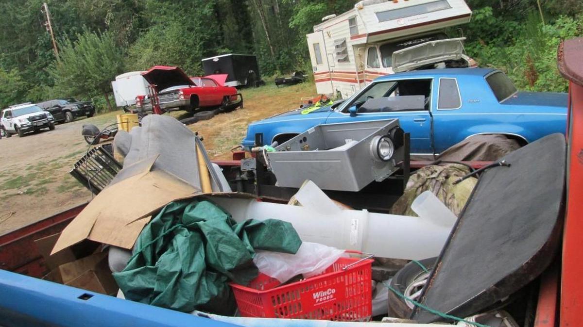 Vehicles and other items litter this property on Chapman Drive NW in Gig Harbor which police say was being used as a chop shop.