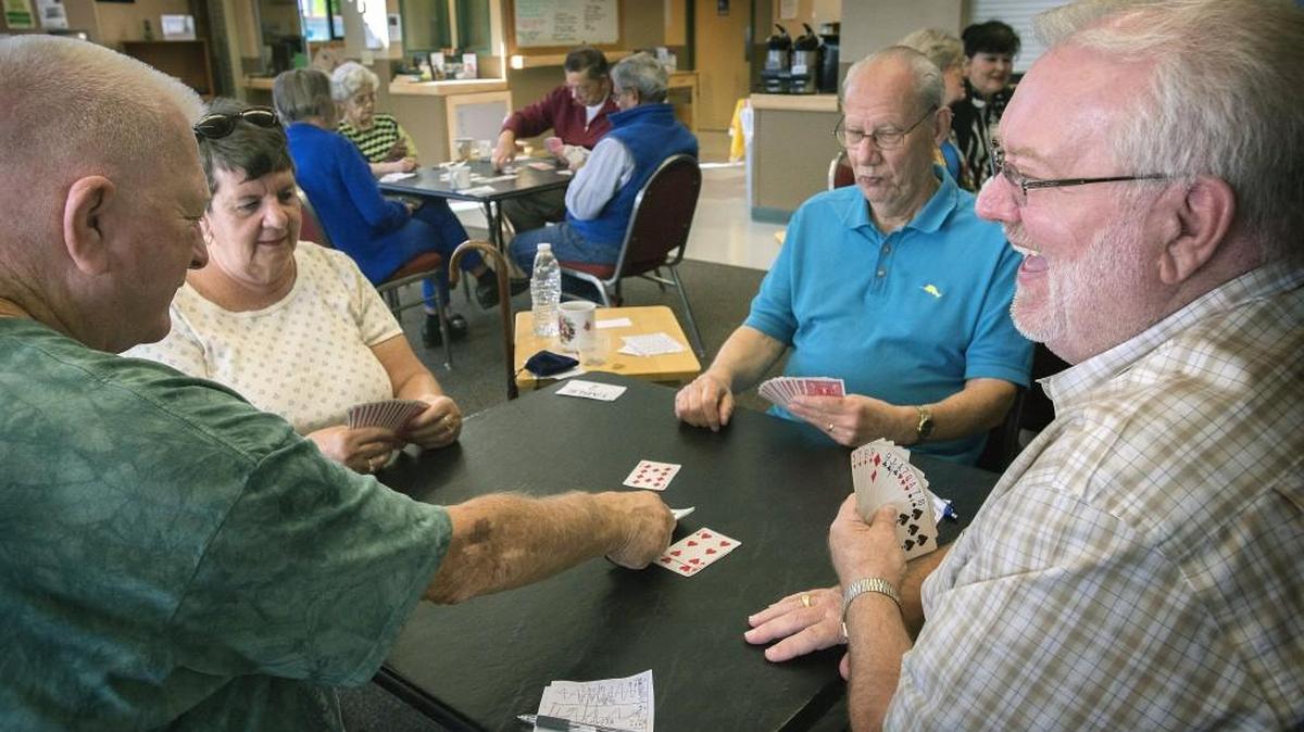 
Marvin Dahl, right, laughs while  playing bridge with, from left, Paul Cutler, 80; B.J. Ogden, 69, and Don Wilbur, 85, at University Place Senior Center in University Place on Tuesday. In 2017, the city will no longer pay for  recreation programs like its many senior activities.
