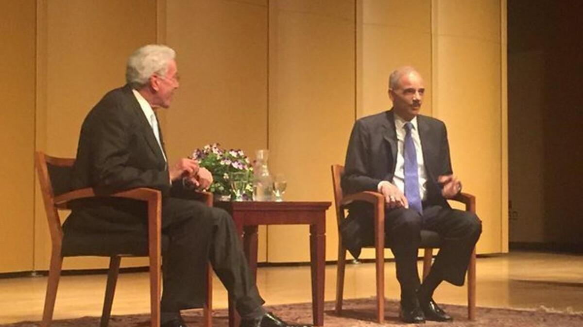 Former U.S. Attorney General Eric Holder, right, and attorney Michael Reiss took part in an hourlong chat Thursday night at the University of Puget Sound.
