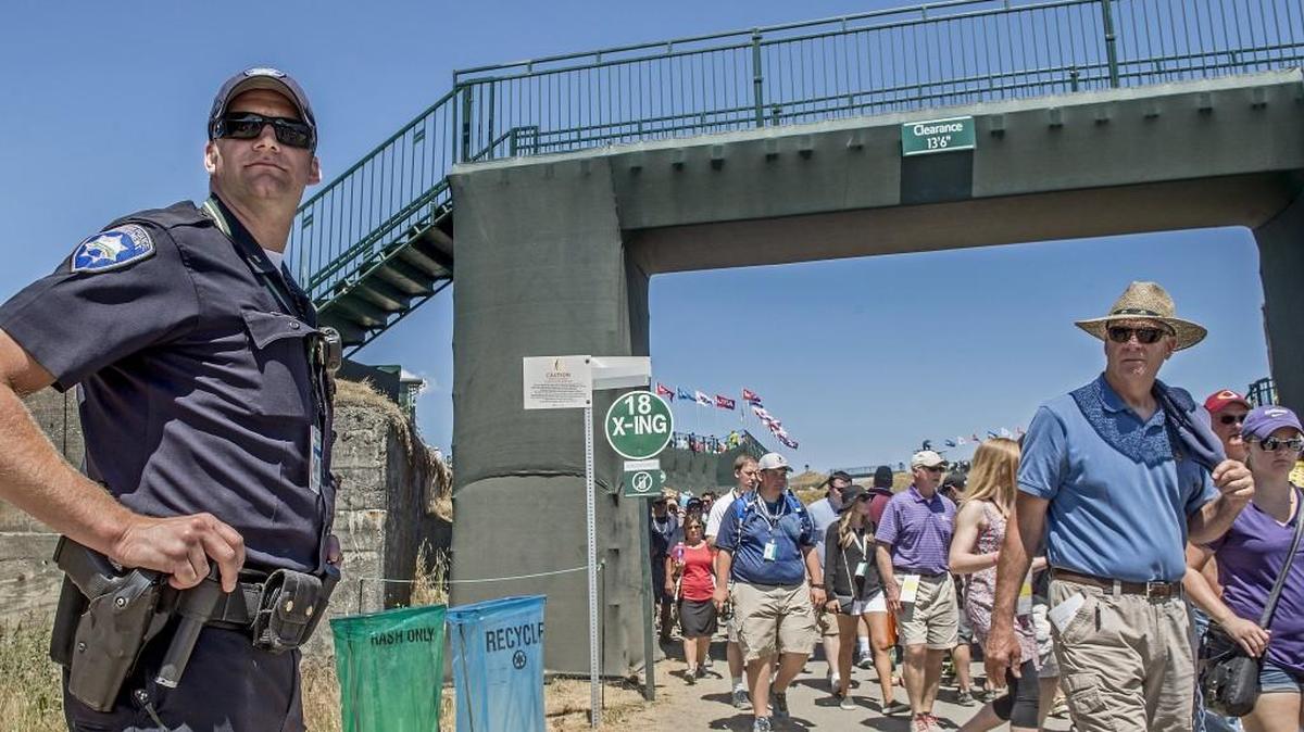 
Mike McQuade of the Tacoma Police Department stands on a course path during the third round of the U.S. Open at Chambers Bay in June. McQuade said he was on his third day of overtime.
