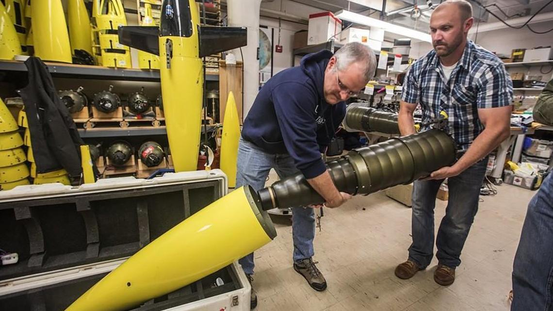 University of Washington oceanographers Jason Gobat and Ben Jokinen assemble a Seaglider, an underwater drone that will be used in an Antarctic expedition to gather data to estimate future ice melt and sea-level rise.