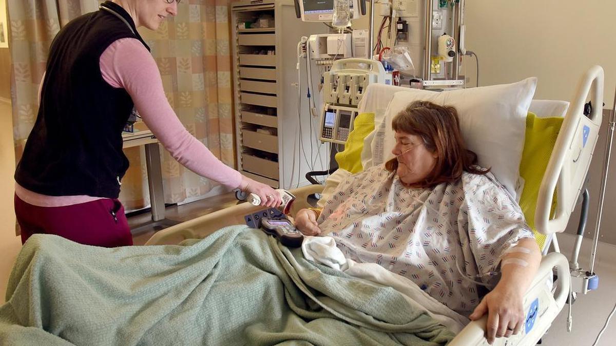 Resting in her Providence St. Peter Hospital room Tuesday after successful leg surgery, Kathryn Van De Coevering has her hospital wrist tag scanned by RN Mia Tibbals before she gets some post-operation medication. Providence has received an A grade from LeapFrog.