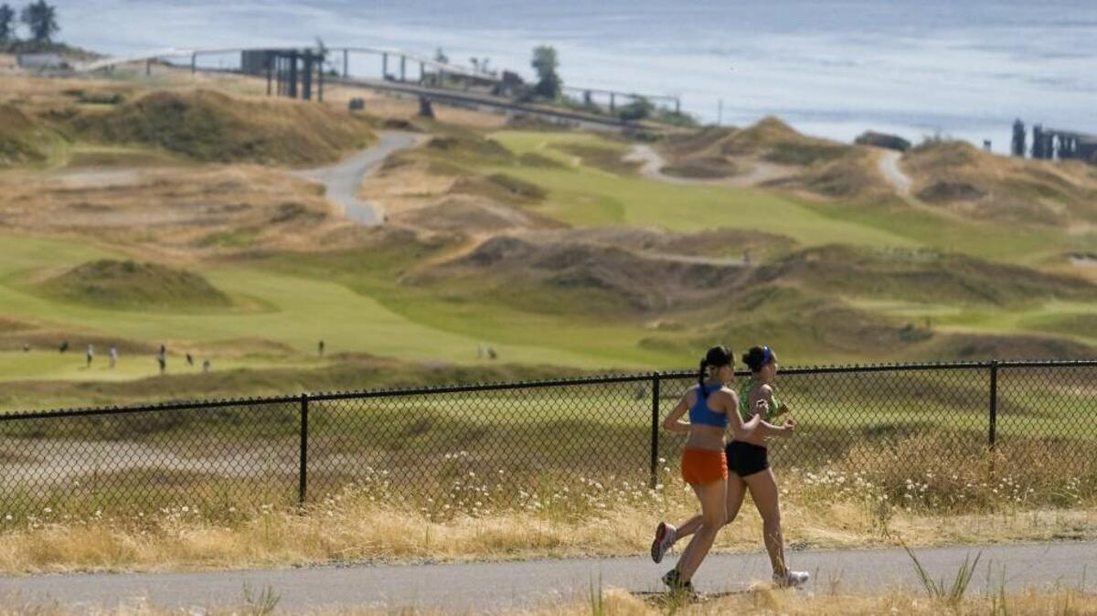 Runners head toward the sound along Grandview Trail through the North Meadow at Chambers Creek Regional Park. Pierce County is updating its master site plan for the 930-acre park including potential development of its southern end for passive and active recreational uses.