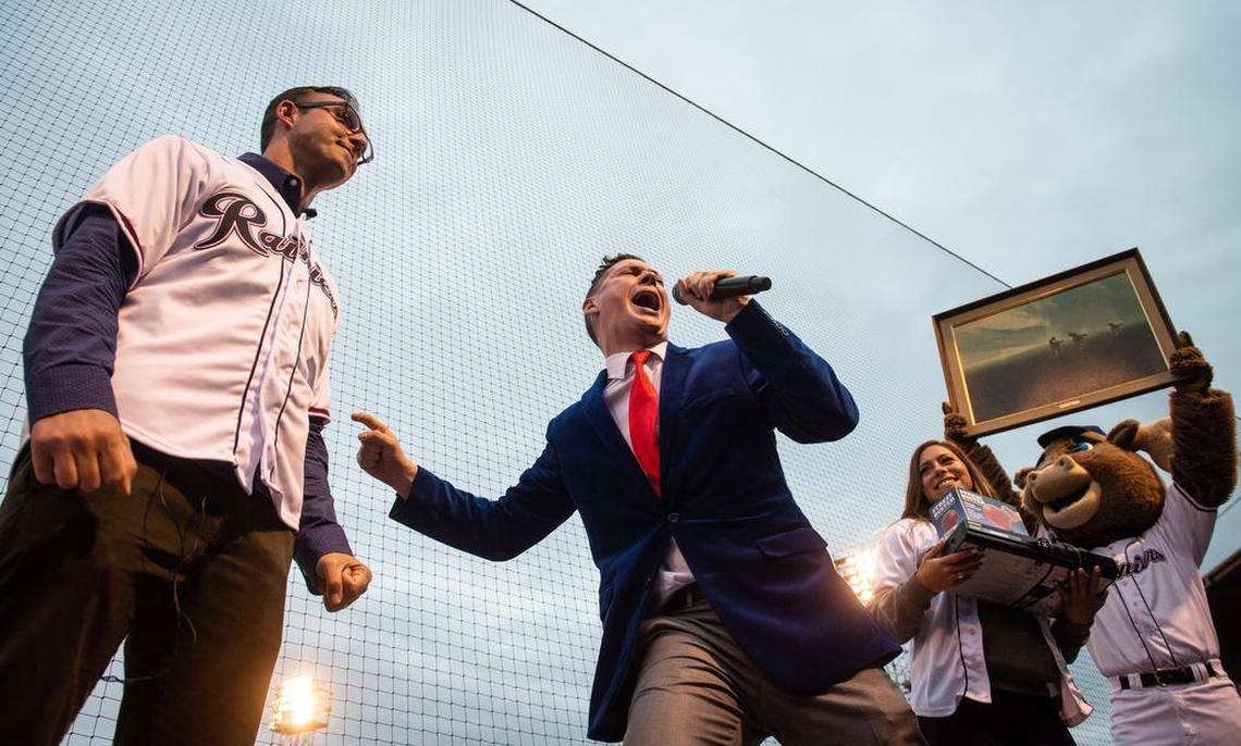 Casey Catherwood, creative director at the Tacoma Rainiers, announces Columnist Matt Driscoll as the winner of “This or That,” a between-inning gameshow during the Tacoma Rainiers’ game against the Las Vegas 51s at Cheney Stadium in Tacoma, Wash., on Thursday, June 28, 2018. Driscoll won a horse painting, a stress-relief punching bag, and Catherwood’s old Blu-Ray player as prizes.