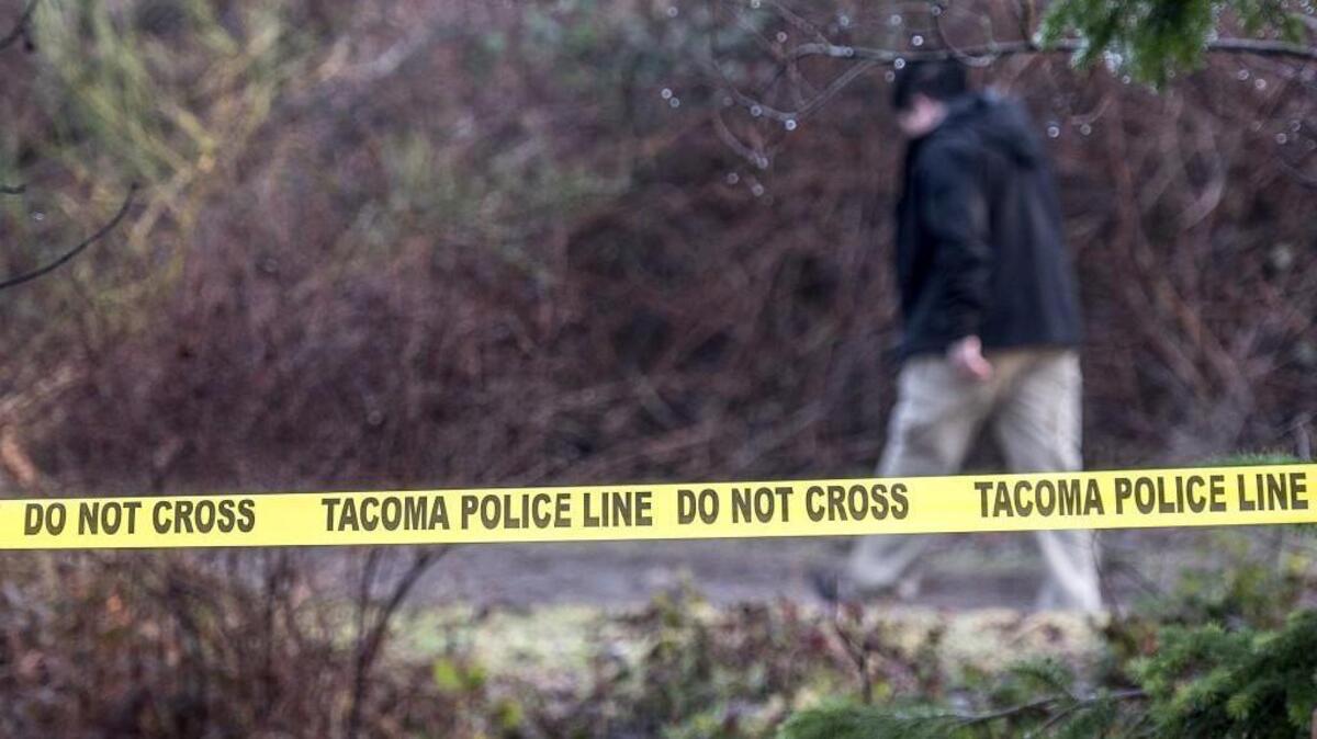 Tacoma Police spokesperson Loretta Cool arrives Wednesday at the scene where human bones were discovered by a walker and dog late Tuesday afternoon along a well-used trail at the Tacoma Community College campus.