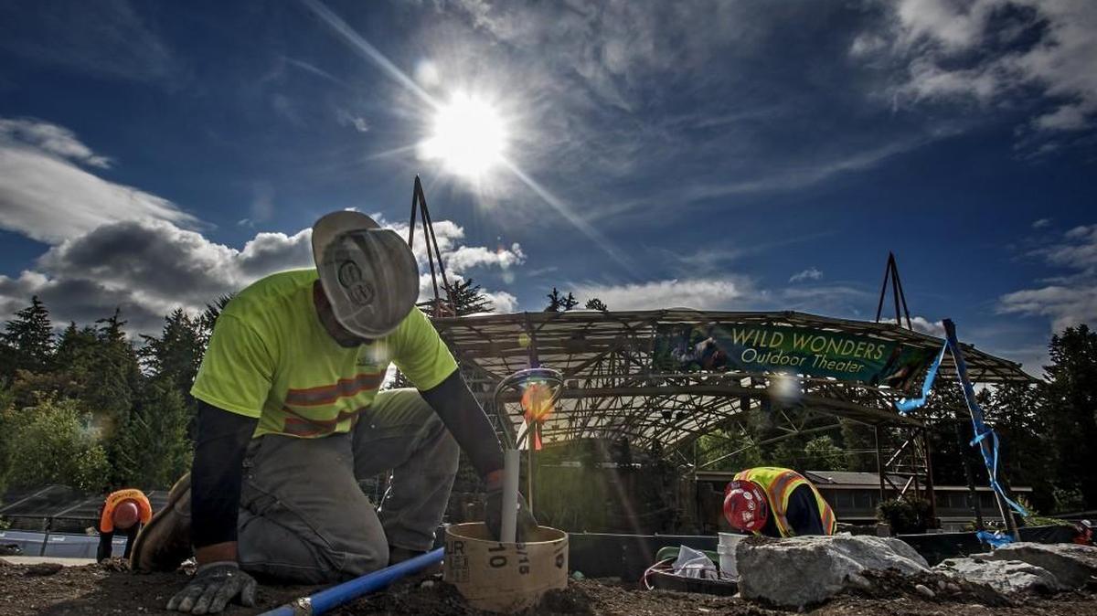 A construction crew arworks on an American Disabilities Act ramp in June that will eventually lead to the new 250,000-gallon aquarium at the Point Defiance Zoo scheduled to open in 2018.