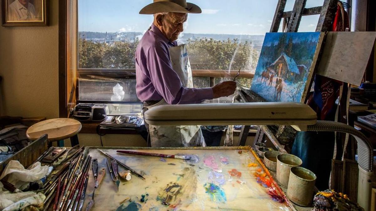 
Western-themed oil painter Fred Oldfield works in his home studio overlooking the water in Tacoma on Thursday. His work is the inspiration for the Fred Oldfield Western Heritage Center at the Washington State Fair.
