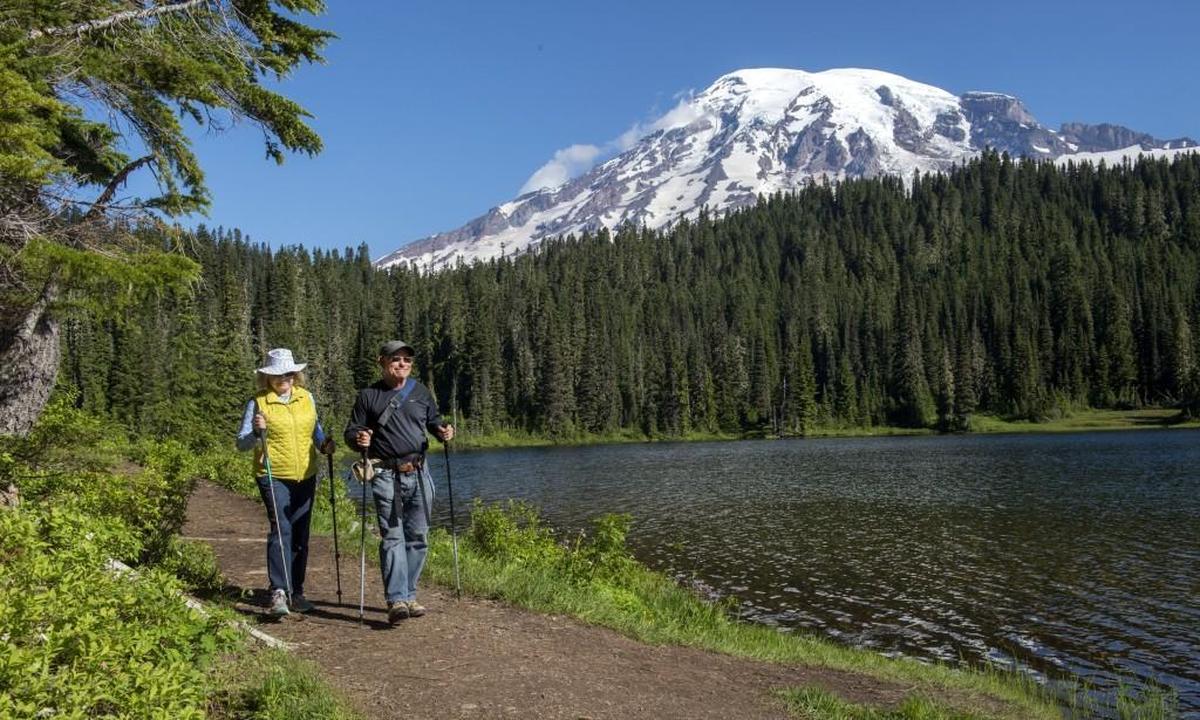 Mike and Sharon Cahn of Eugene, Oregon, walk the Wonderland Trail along Reflection Lake at Mount Rainier National Park on Wednesday, July 20, 2016.
