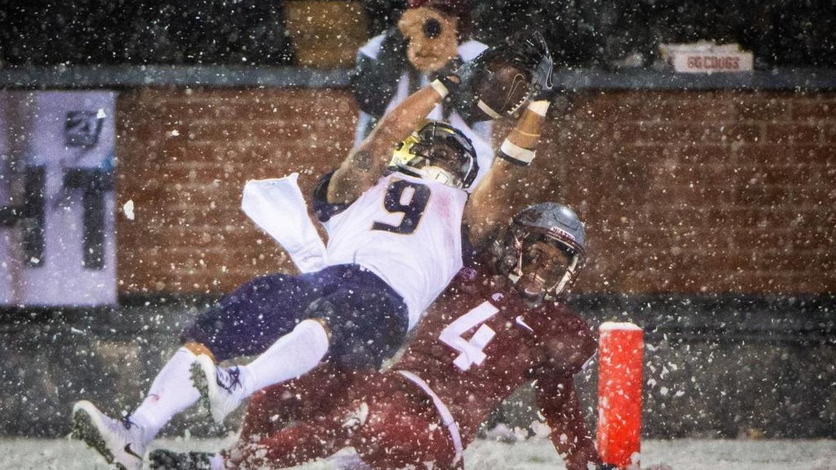 Washington running back Myles Gaskin (9) dives into the end zone as he’s tackled by Washington State’s Marcus Strong in the third quarter. The rush gave Gaskin over 1,000 yards rushing for the fourth year in a row. The Washington Huskies played the Washington State Cougars in the Apple Cup at Martin Stadium in Pullman, Wash., on Friday, Nov. 23, 2018.