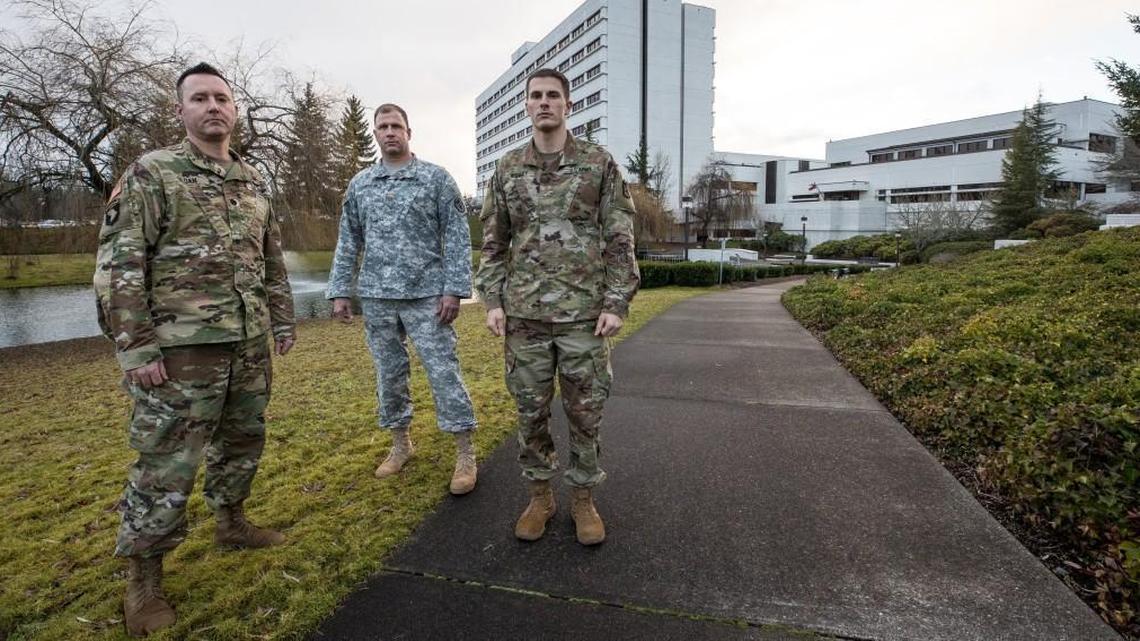 Madigan Army Medical Center staff members Lt. Col. D. Chris Sloan, left, Maj. Mike Livingston, center, and Lt. Robert McCoy of the 62nd Medical Brigade were among the first responders at the scene of Monday’s Amtrak train derailment. They helped several passengers evacuate from the rail car hanging over the bridge onto I-5.