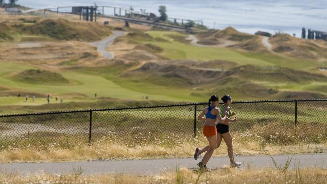 Runners head toward the sound along Grandview Trail through the North Meadow at Chambers Creek Regional Park. The Pierce County Council authorized development of a resort on the property Tuesday.