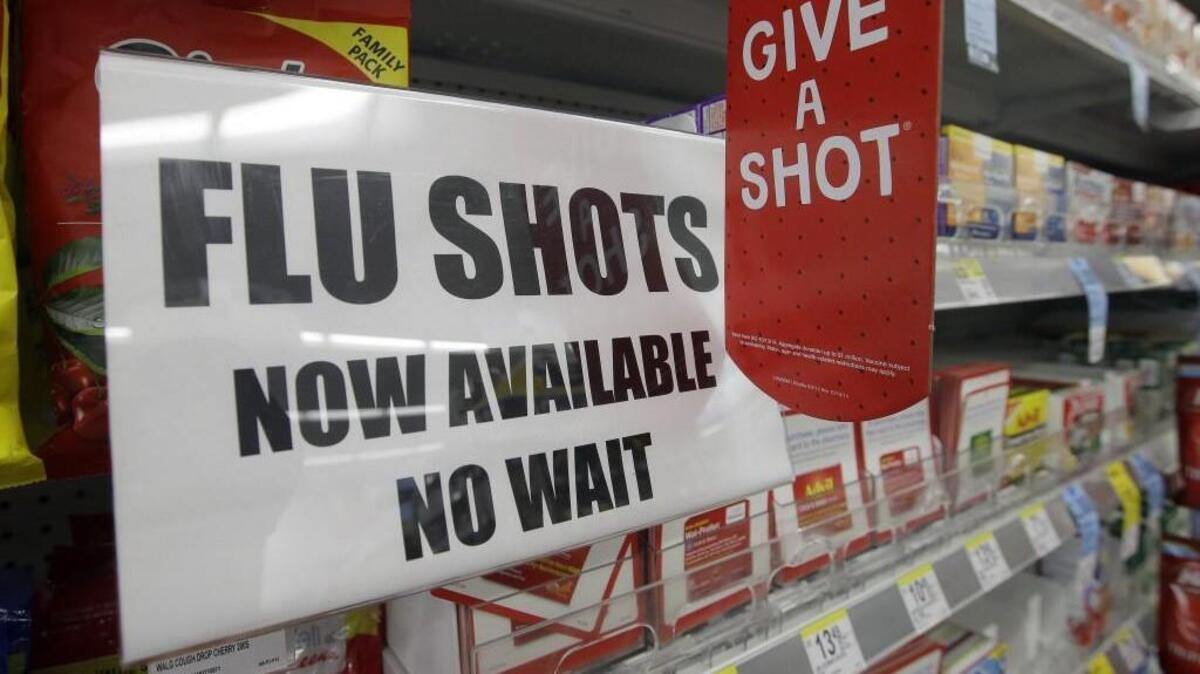 A sign telling customers that they can get a flu shot in a Walgreen store is seen in Indianapolis.