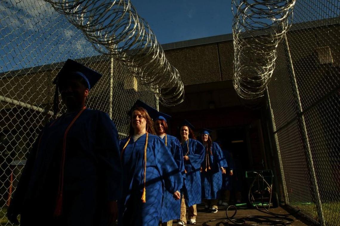 Nineteen women at the Washington Corrections Center for Women in Gig Harbor proudly walk in their royal caps and gowns to their college-graduation ceremony earlier this month. The women earned associate degrees in liberal arts from Tacoma Community College.