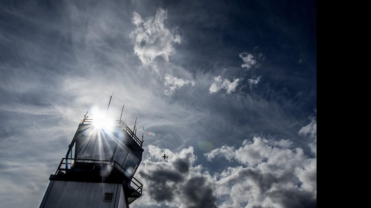 
A private plane flies by the control tower at Tacoma Narrows Airport on Monday.
