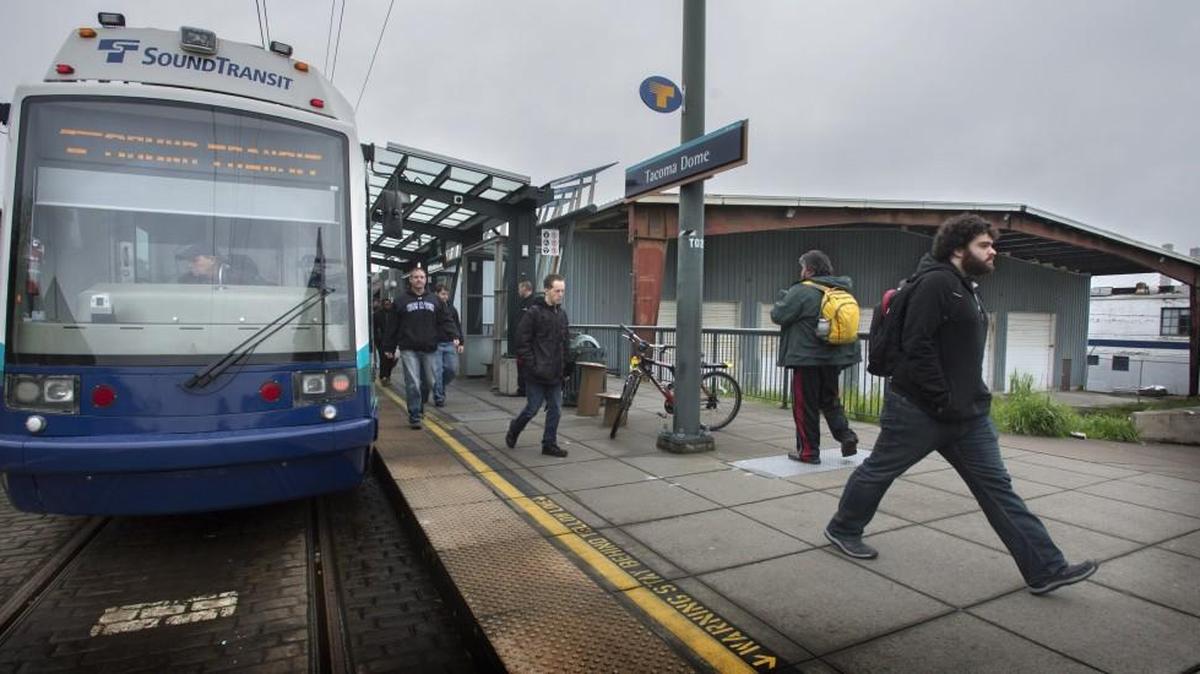 Link passengers disembark and head to the Tacoma Dome Station parking building on Wednesday. Pierce Transit is making another run at creating a “transit-oriented development” in the area.