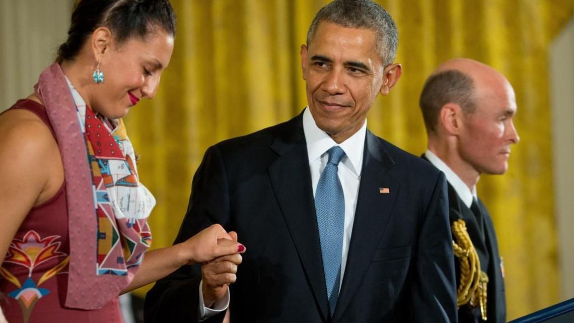 President Barack Obama helps Peggen Frank to the lectern as she accepts the Presidential Medal of Freedom for her father-in-law, the late Nisqually tribal advocate Billy Frank Jr., on Tuesday.