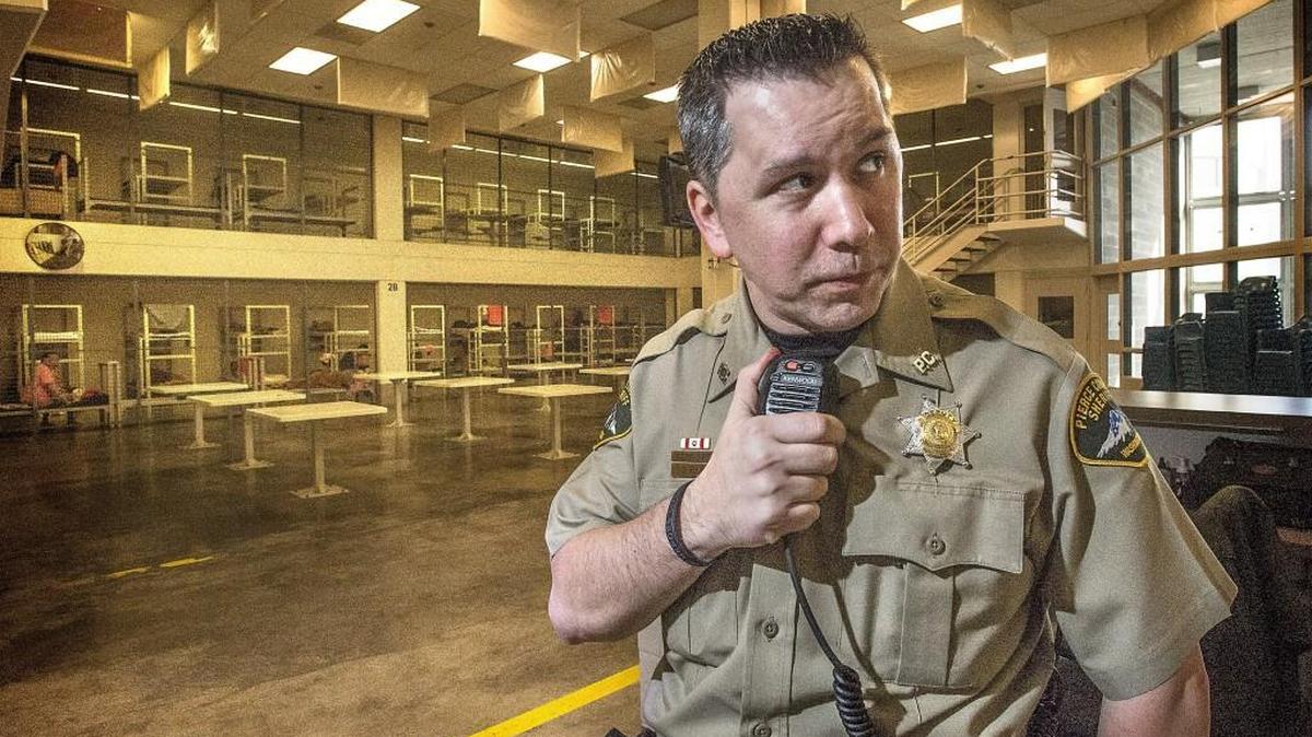 Jon Blind, a corrections officer at the Pierce County Jail, uses an “old” Kenwood radio because of dead zone issues with the 162 new Motorola radios purchased by the county with South Sound 911 money. The Motorola radios’ wireless signal is blocked by the jail’s concrete block walls, rebar and bulletproof glass.