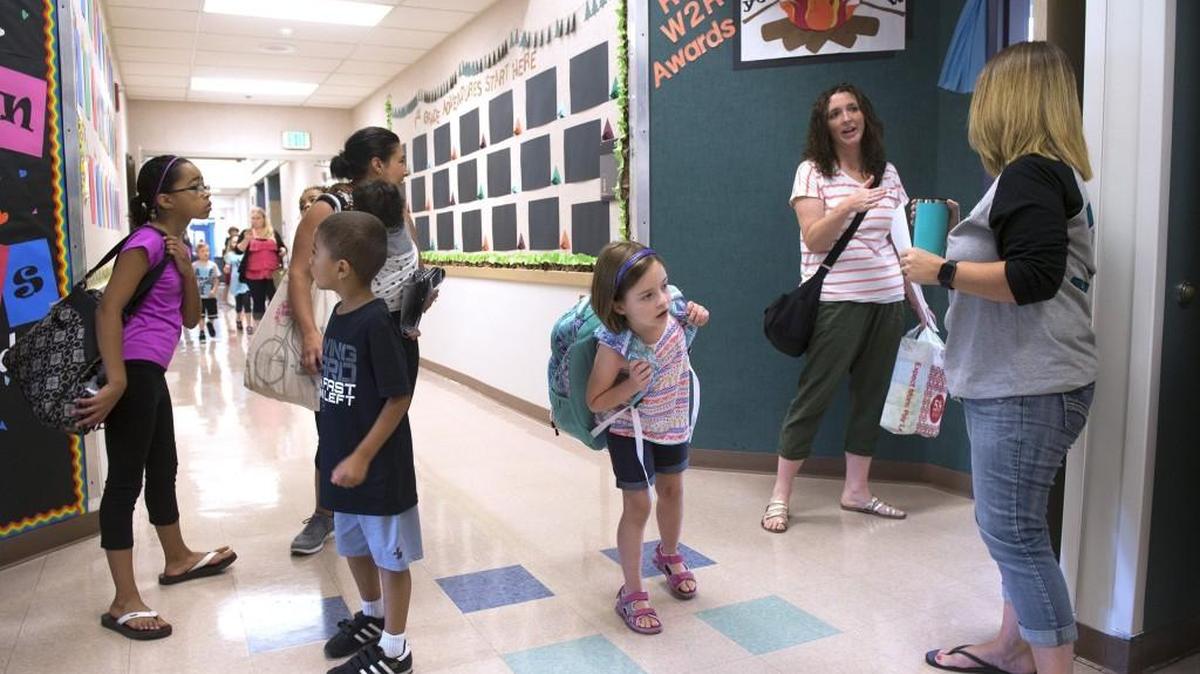 Students and families tour the new 12-classroom expansion at Shaw Road Elementary in Puyallup following a ribbon-cutting ceremony Aug. 29, 2017. Some school districts are struggling to figure out how to implement the state Legislature’s school-funding fix.