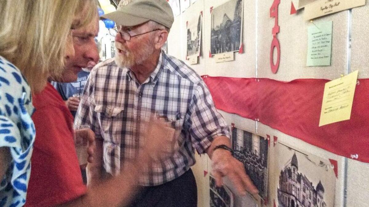 
Bob Arnold points to an old photo of the city’s opera house and explains its history, as he remembers it, to a group of guests at Puyallup’s 125th anniversary celebration at the Pioneer Park Pavilion, August 19, 2015. Arnold is a retired teacher who has lived in the same home in the city for more than 50 years.
