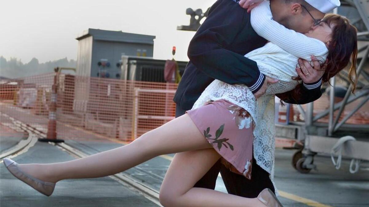 U.S. Navy logistics specialist 3rd class Michael Zegarra, of Miami, sweeps his wife Caterina Zegarra off her feet Sunday, Dec. 10, 2017, after returning to Bremerton on the aircraft carrier USS Nimitz. The Nimitz Carrier Strike Group returned from a regularly scheduled deployment from the Indo-Asia-Pacific region and Arabian Gulf which supported Operation Inherent Resolve.