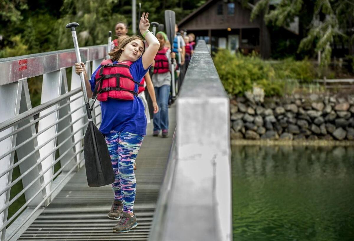 Katherine Hamilton dances down the bridge at YMCA Camp Seymour on the Key Peninsula on Aug. 10, 2016. More than 180 children of families in the military who are injured, disabled or are dead were in camp for a week through a national program called Camp Corral.