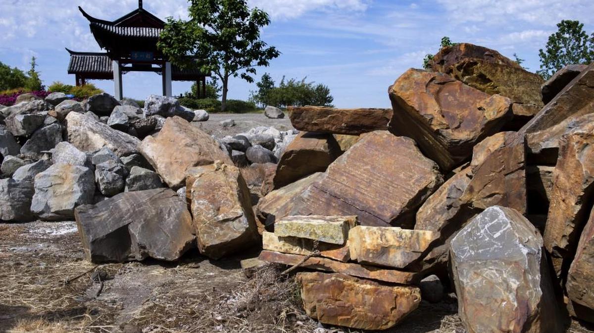 A small pile of decorative rock (foreground) was returned by a University Place man Friday after he was recently caught on camera stealing them from Chinese Reconciliation Park in Tacoma. Photo taken on Friday, May 13, 2016
