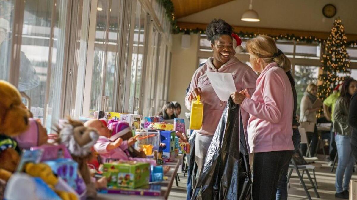Britnee Blockman is delighted with what she’s getting for her two kids at the Toys for Tots toy giveaway Saturday at the Tacoma Elks Lodge.