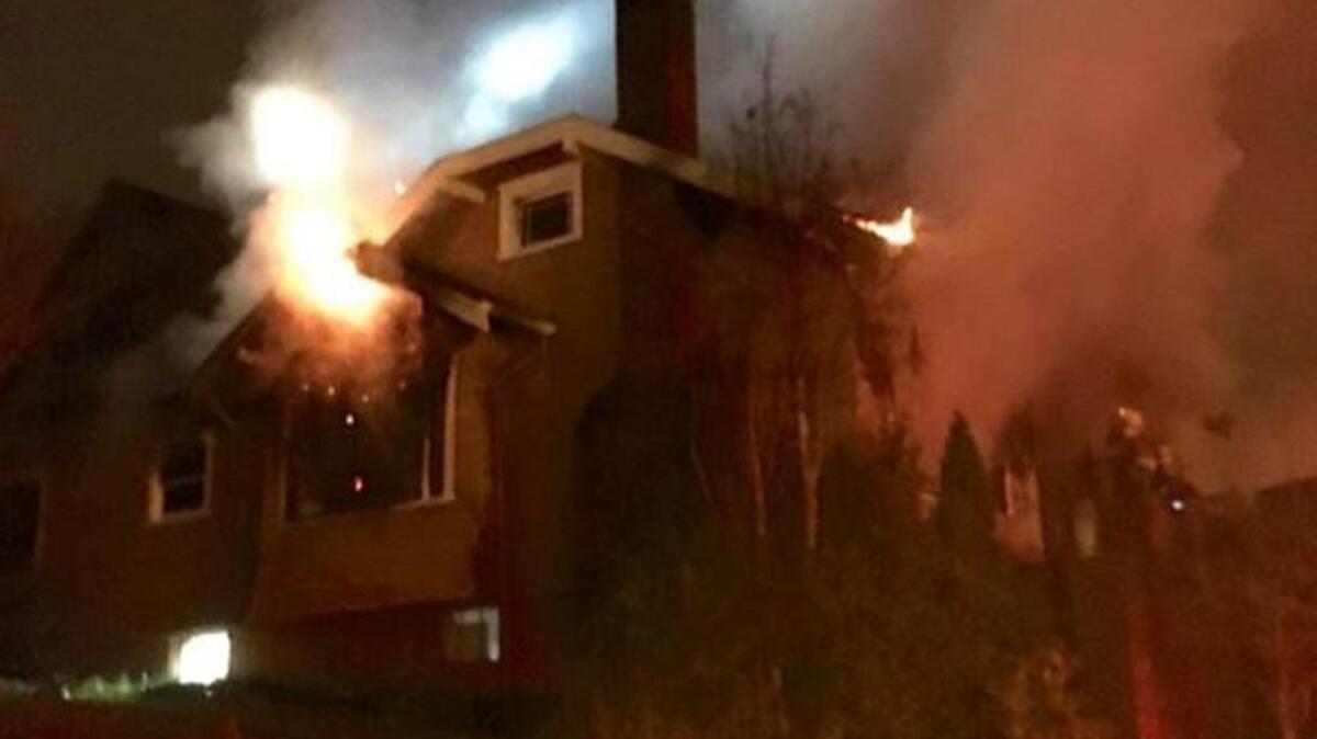 Fire ravages a home on North Stadium Way early Wednesday. An 87-year-old sustained critical injuries in the fire and died.