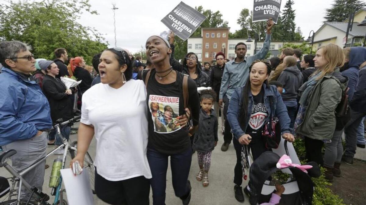People begin marching after a vigil outside where Charleena Lyles was shot and killed Sunday by police in Seattle.