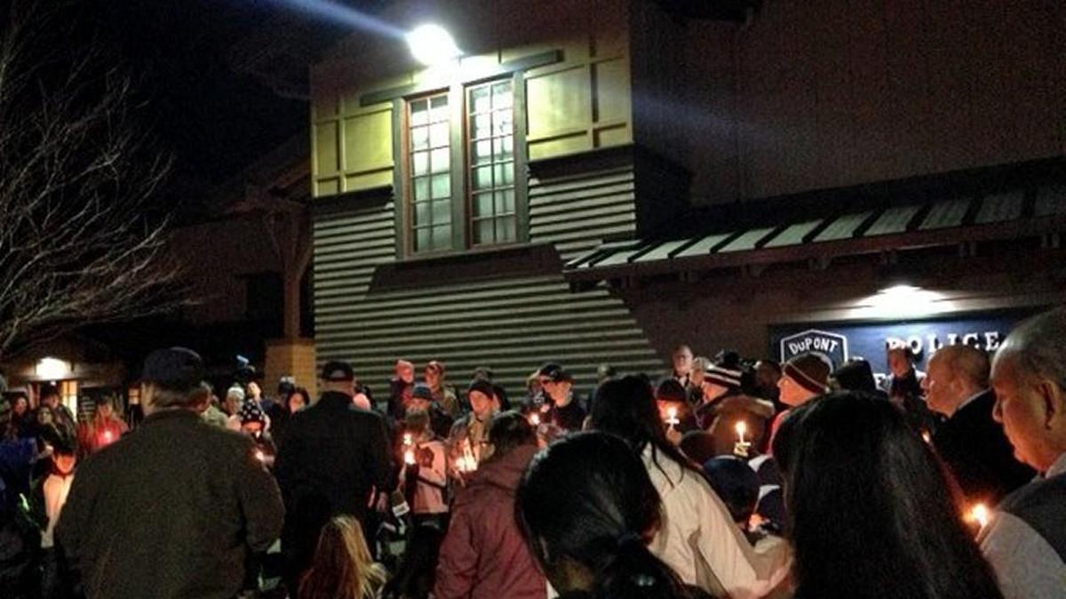 DuPont residents gather Wednesday evening for a candlelight vigil to commemorate the victims and those affected by Monday’s Amtrak derailment.
