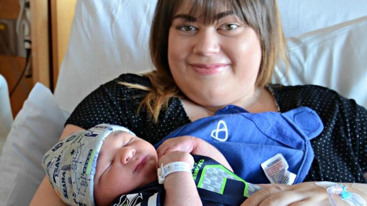 Hunter Edward Rose, in the Seahawks beanie, arrived at 12:25 a.m. on New Year’s Day, the first baby of 2016 in Pierce County. His mother, Amanda Rose, is awfully proud.