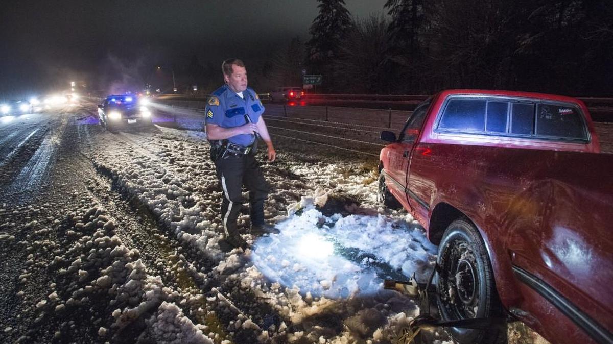 Washington State trooper Eric Ludlow monitors a truck that spun out eastbound on Highway 16 in Gig Harbor on Monday, Fed. 6, 2017. "We've been busy all morning," said Ludlow of snow-related accidents. "The pickups are always the first to go." The driver was unhurt and had left the scene.