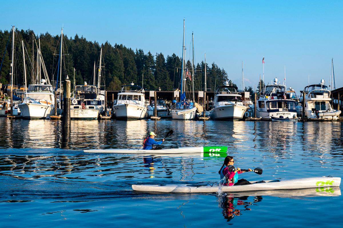 Kayakers paddle through the calm waters of Gig Harbor on Wednesday, Oct. 12, 2022. Even though summer has seemed to last longer than usual rain is forecasted throughout the South Puget Sound Area in the coming week.