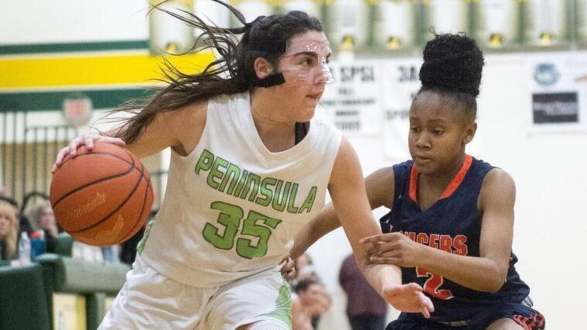 Peninsula’s Belle Frazier drives on the Lakes’ Amber Nealy in the opening round of the Class 3A West Central III/Southwest bidistrict basketball tournament on Feb. 7, 2018.