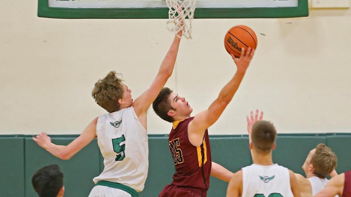 Capital guard Chris Penner (15) drives to the basket at the Peninsula Seahawks vs. Capital Cougars boys basketball game at Peninsula High School in Purdy, Wash., Friday, Dec. 8, 2017. Capital wins 70-62. Penner finished the game with 34 points.