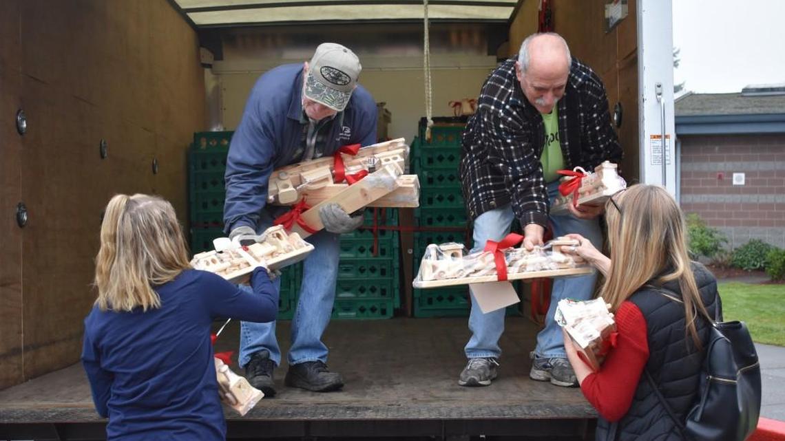 Volunteers from South Kitsap Helpline help Goodman Middle School students load items provided by the community to make the holiday season brighter for those in need.