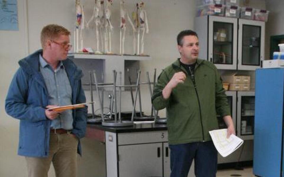 In a science-related classroom at Peninsula High School, district facilities director Patrick Gillespy, right, describes some of the upgrades the district is contemplating for future improvements during a Saturday tour.
