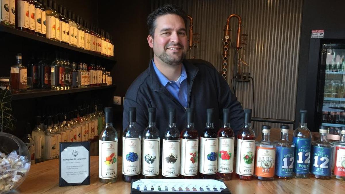 Heritage Distilling owner Justin Stiefel stands behind the bar of the company’s downtown Gig Harbor location shortly after it opened.