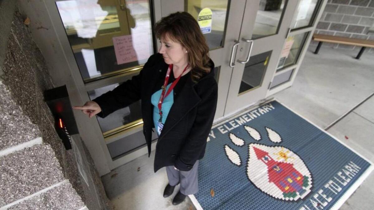 Bridget Reichel, assistant principal at Purdy Elementary School, uses the security keypad at the school’s main entrance.